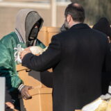 His Eminence Metropolitan Nathanael helping distribute food those most in need.