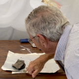 Dr. Alexandrakis unknowingly looking at his grandfather’s wallet recovered from mass grave site