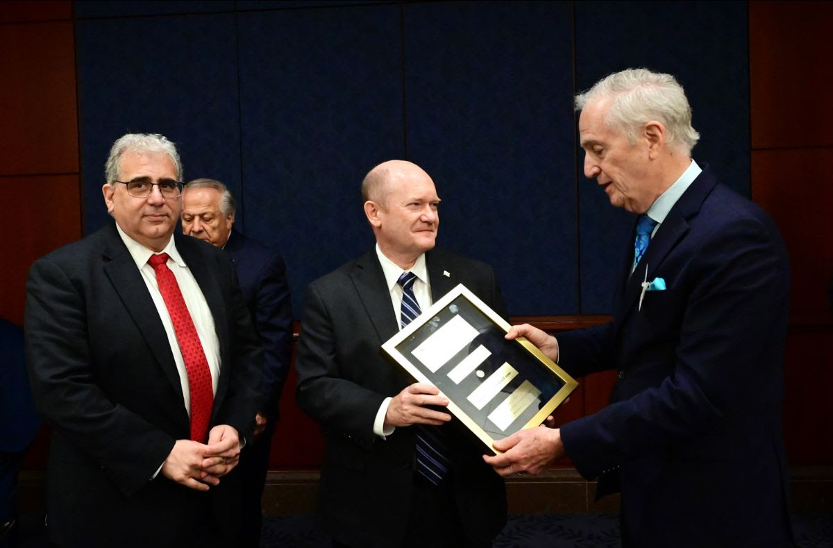 Senator Coons, who was introduced by Delaware State Senator Spiros Mantzavinos, is presented with the Paraskevaides/Mouyiaris Award by Andy Manatos