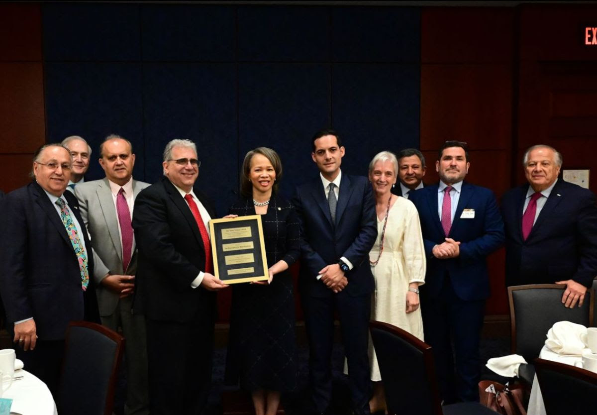 Delaware State Senator Spiros Mantzavinos presents Senator Blunt Rochester with the James Williams Award