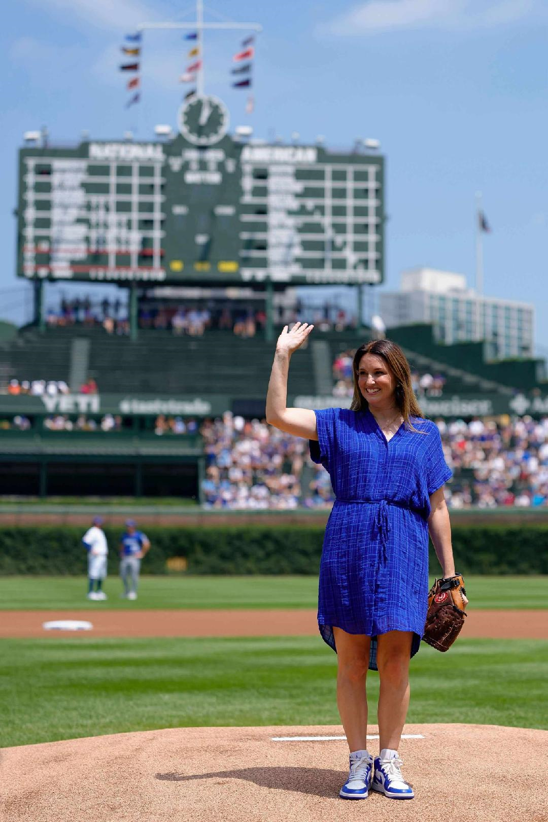 It was a bright, clear day when Jennifer Dedes Nowak - donning her Cubby and Hellenic blue - stepped on the mound to toss the ceremonial first pitch at Wrigley Field during Women in Baseball Week (IMAGE CREDIT: Chicago Cubs)