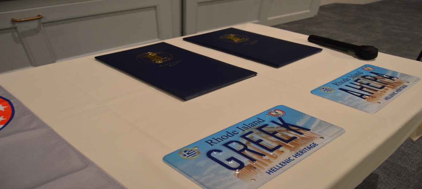 Sample license plates with both Senate and House legislation binders in the background