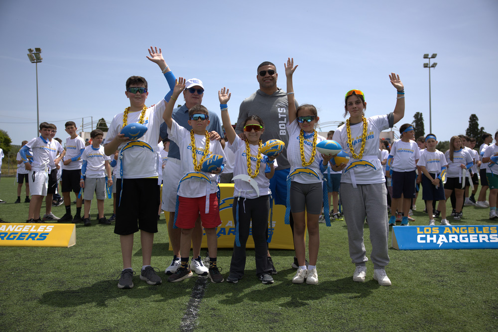 Dean Spanos and Shawne Merriman with the winners of the NFL Flag Football Camp