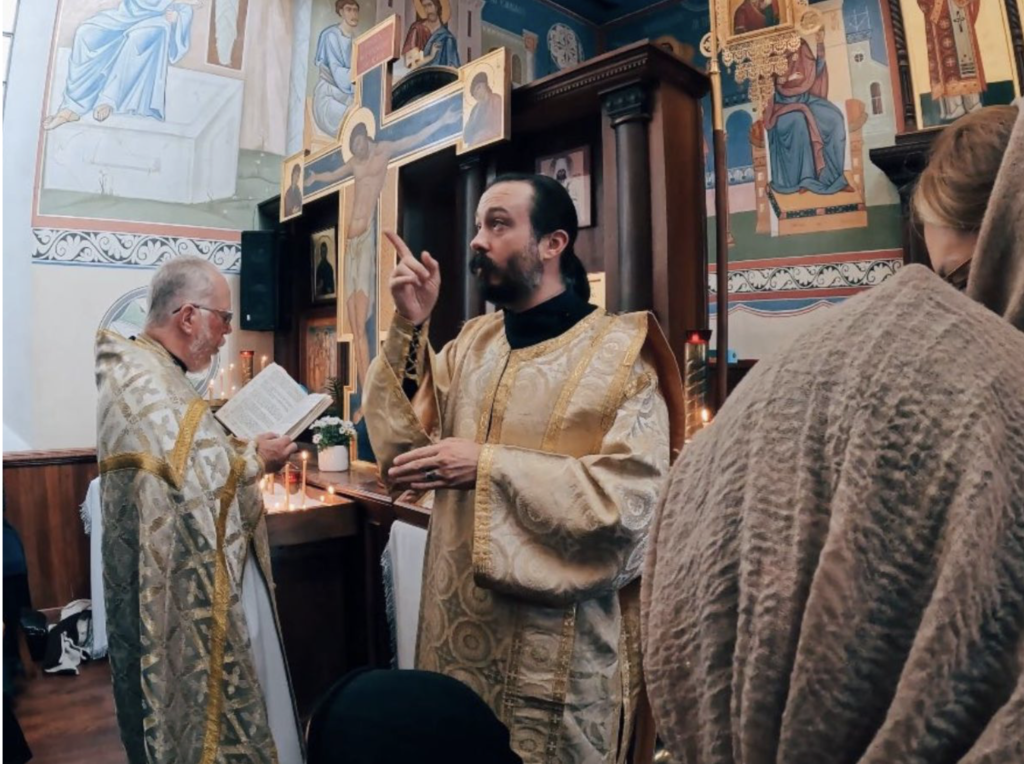 Fr. Davede Thompson signs during the Divine Liturgy. Photo courtesy of Orthodox Christian Deaf Association