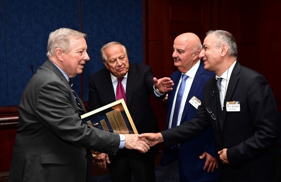 Mayors from Cyprus (left to right) Dr. Iosif Violaris and Marios Zambakides present an award to Sen. Durbin